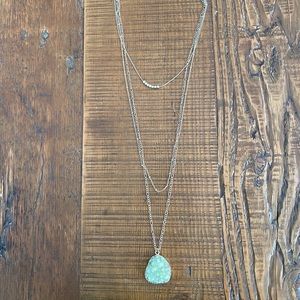 Francesca’s long layered gold and green necklace